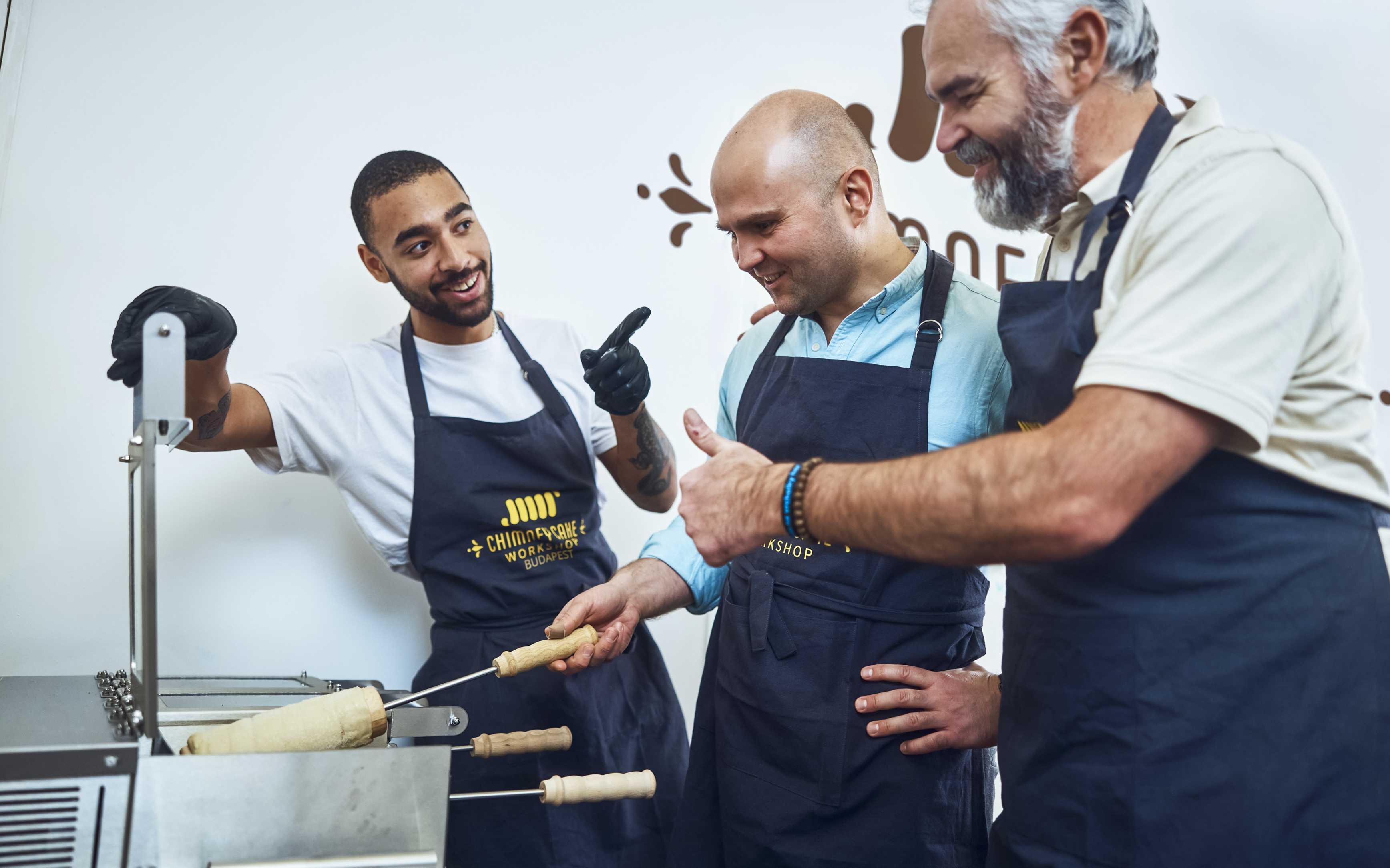 Participants learning to make chimney cakes at a Budapest workshop.