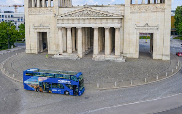 Open-top tour bus in front of Munich's Propylaea on a Hop-On/Hop-Off Express Tour.