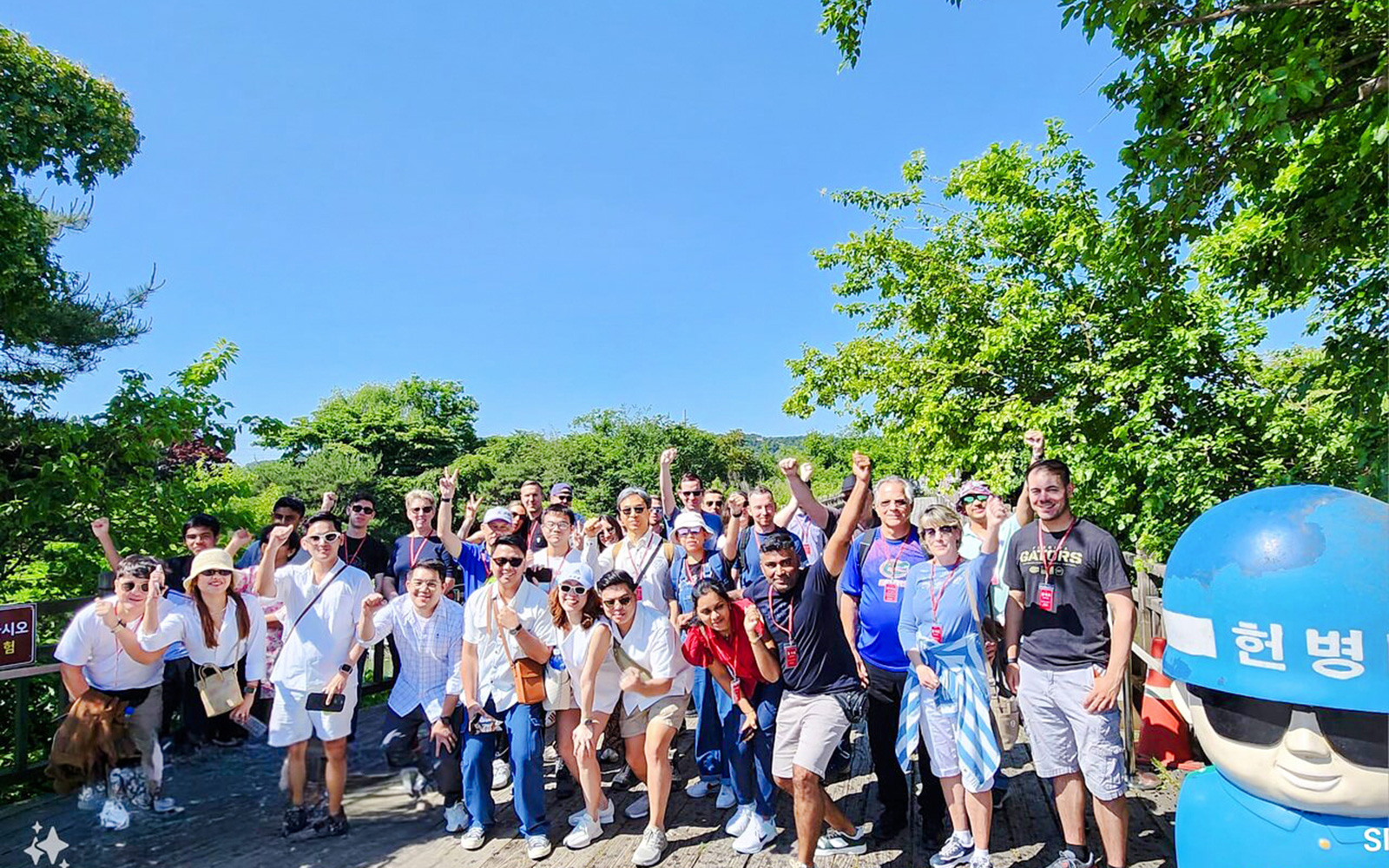 Tour group on wooden path surrounded by trees during DMZ tour from Seoul.