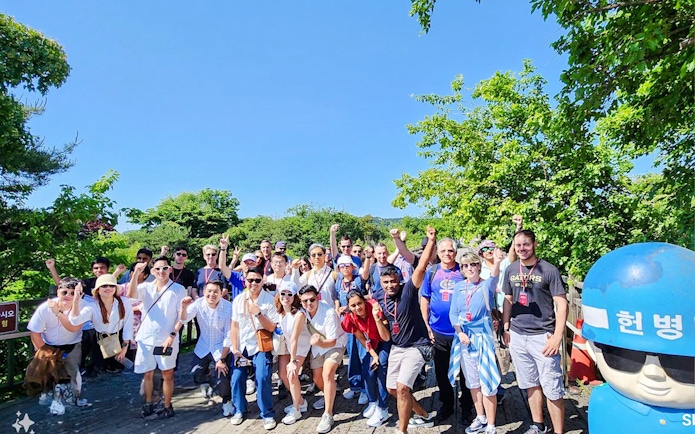 Tour group on wooden path surrounded by trees during DMZ tour from Seoul.