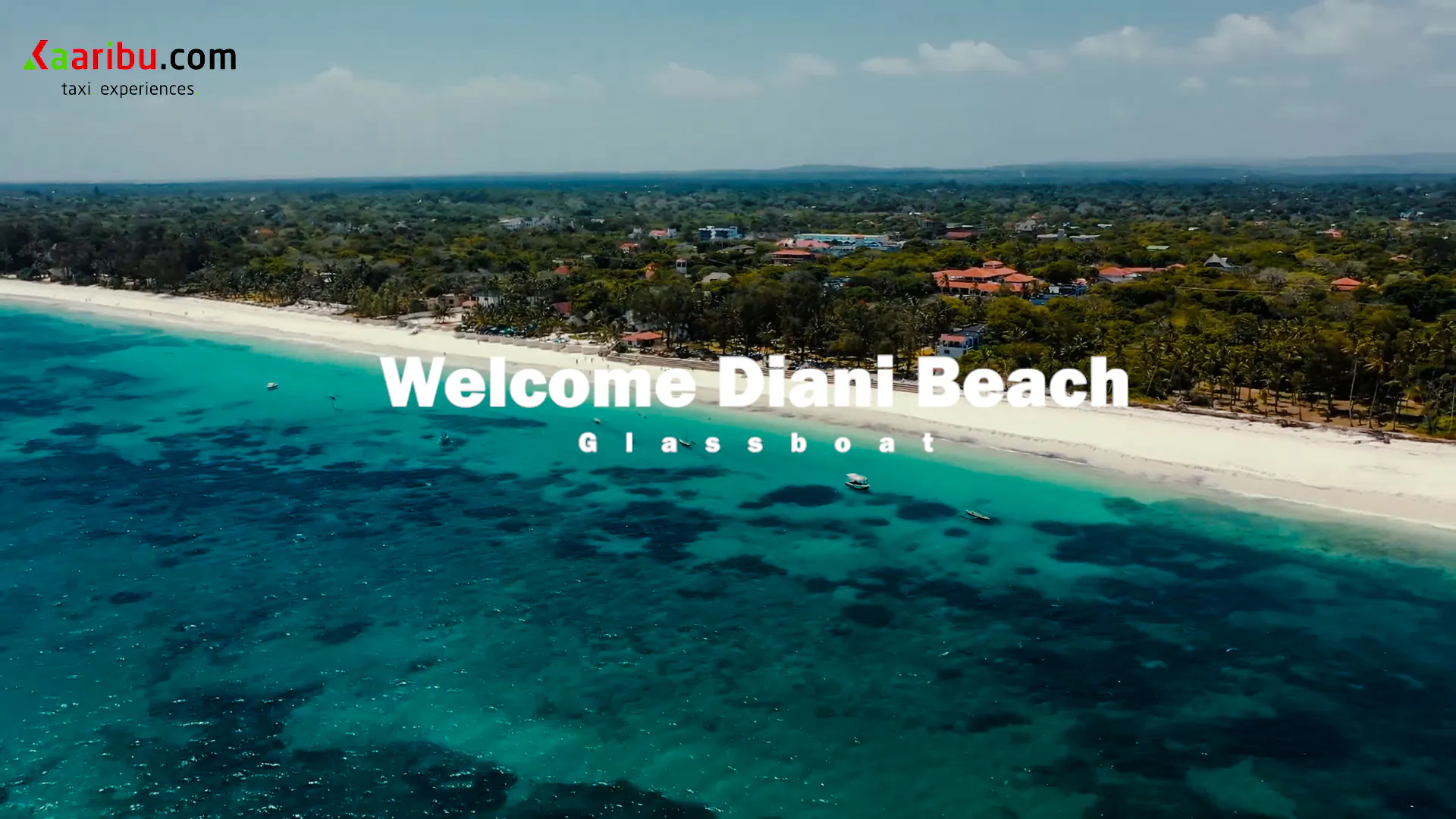 Aerial view of Diani Beach coastline with glass-bottom boats in turquoise water.