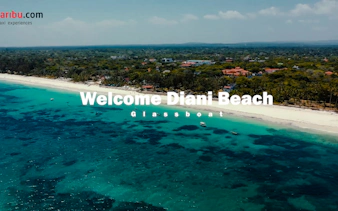 Aerial view of Diani Beach coastline with glass-bottom boats in turquoise water.
