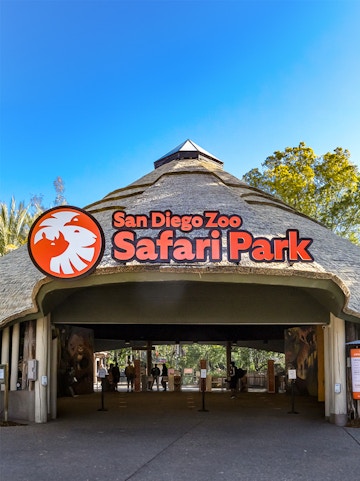 San Diego Zoo Safari Park entrance with thatched roof and signage.