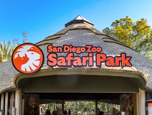 San Diego Zoo Safari Park entrance with thatched roof and signage.
