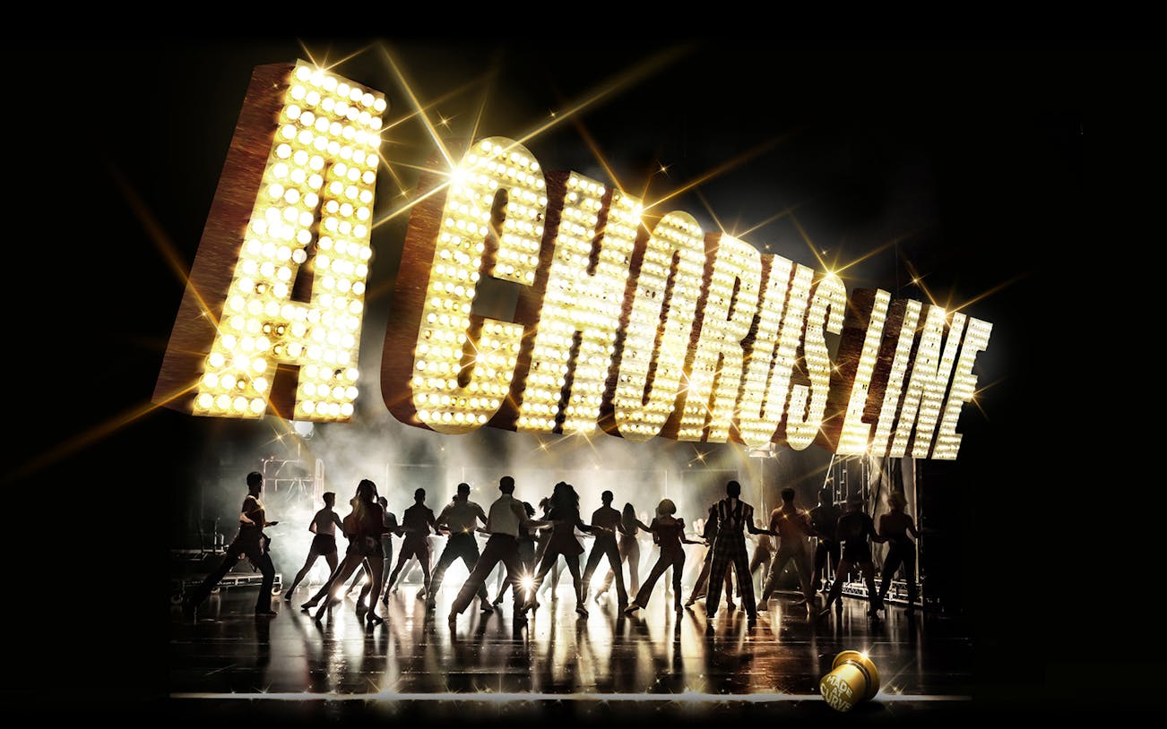 Dancers performing under illuminated "A Chorus Line" sign on stage.