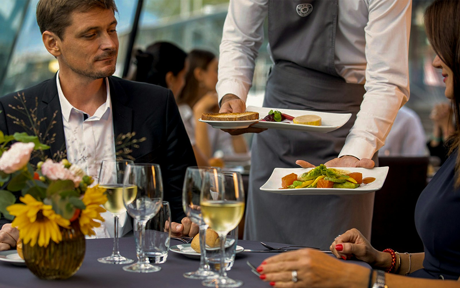 Bateaux Mouches Late Evening Seine River Dinner Cruise With Waiter Serving Fresh Gourmet French Cusisine.