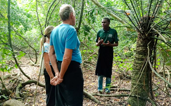 Guide explaining Kaya Kinondo Forest to visitors, Diani Beach.