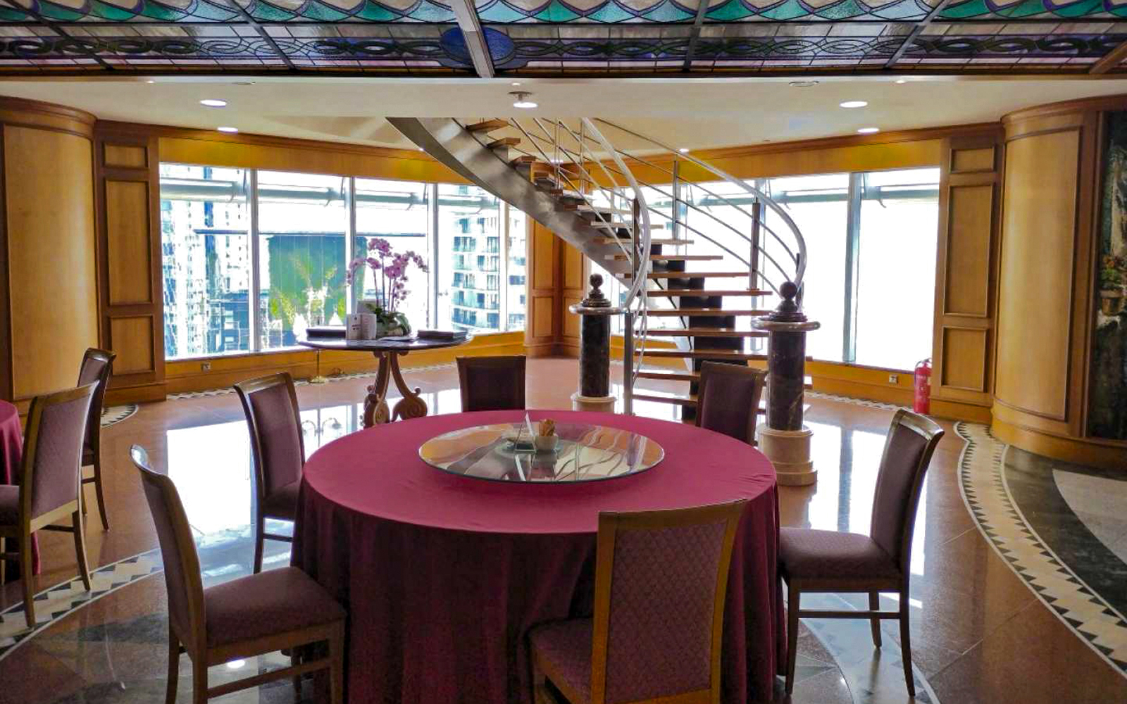 Dining area with round table and spiral staircase, Petronas Twin Towers, Kuala Lumpur.