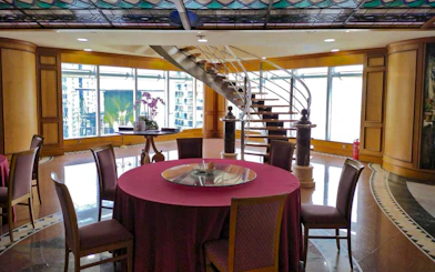 Dining area with round table and spiral staircase, Petronas Twin Towers, Kuala Lumpur.