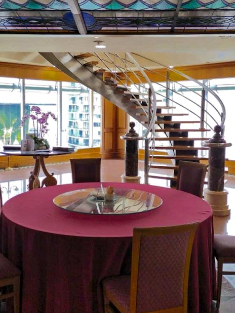 Dining area with round table and spiral staircase, Petronas Twin Towers, Kuala Lumpur.