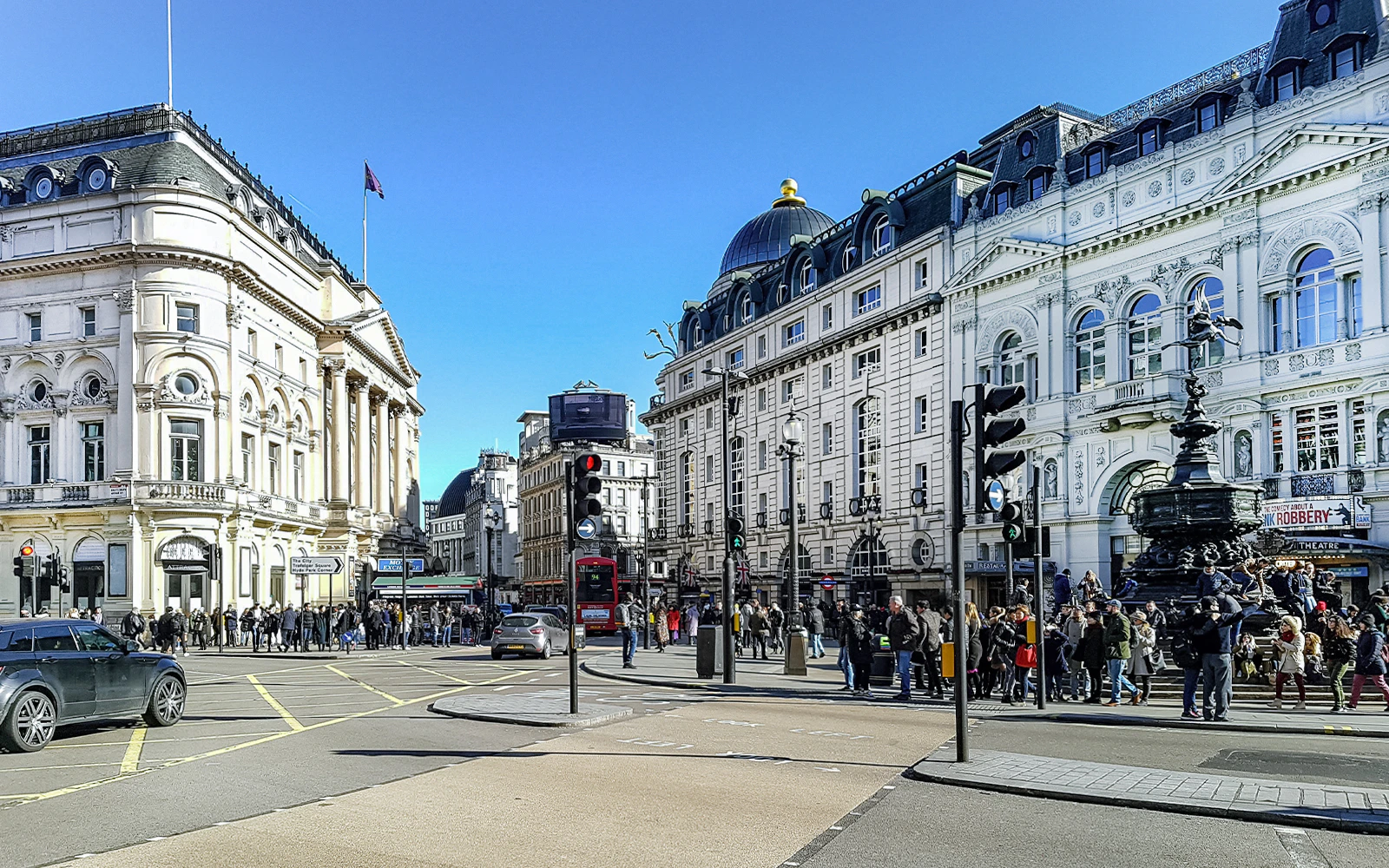 Piccadilly Circus in London with busy street and iconic buildings.