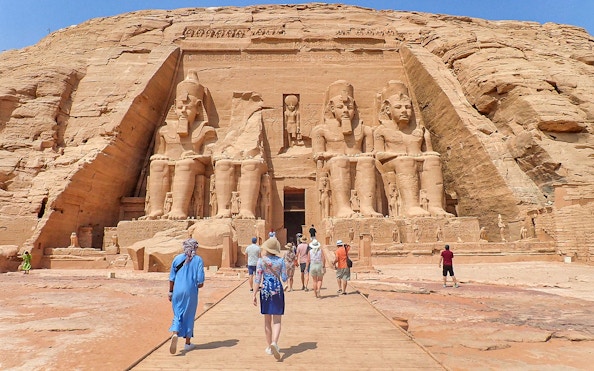 Visitors approaching the Abu Simbel Temple Complex in Egypt.