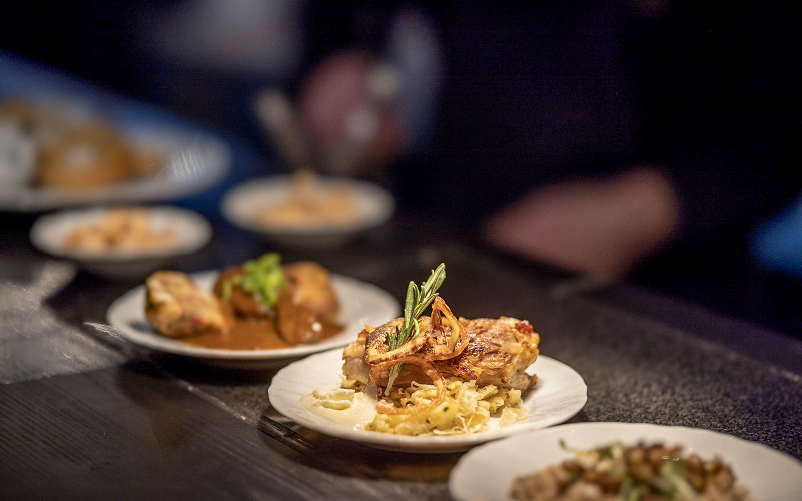 Czech tapas dishes on plates during a cuisine tasting event.