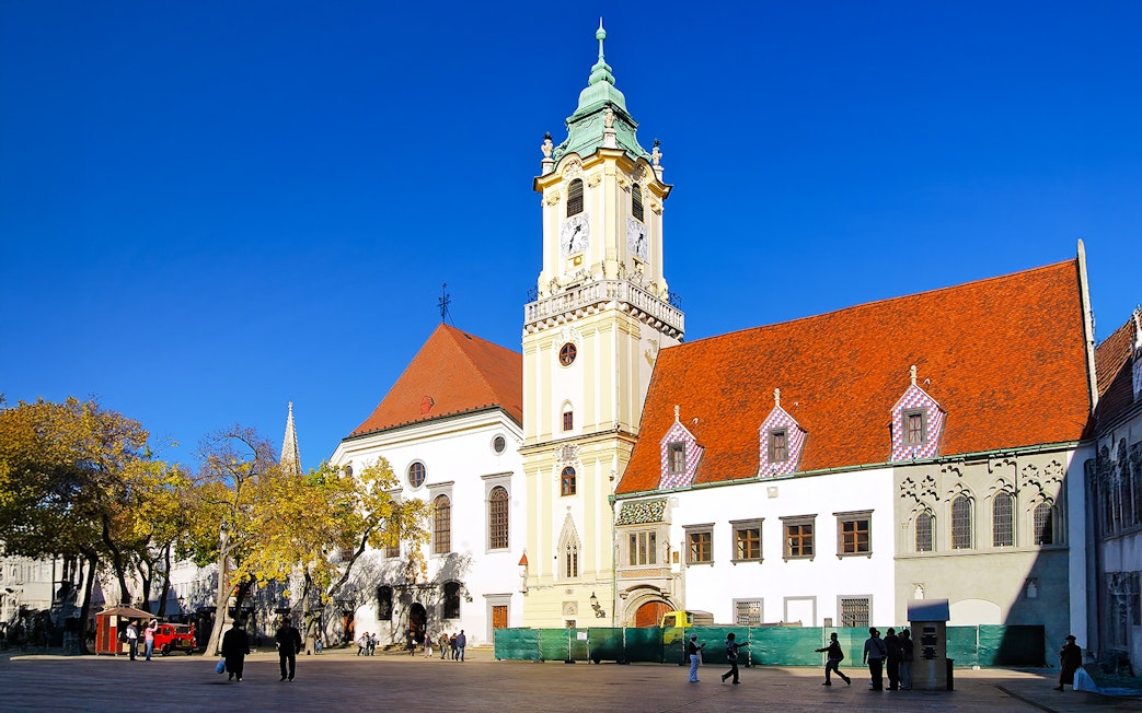 City Hall in the Old Town of Bratislava, Slovakia, with its distinctive clock tower and red roofs.