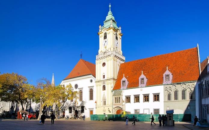 City Hall in the Old Town of Bratislava, Slovakia, with its distinctive clock tower and red roofs.