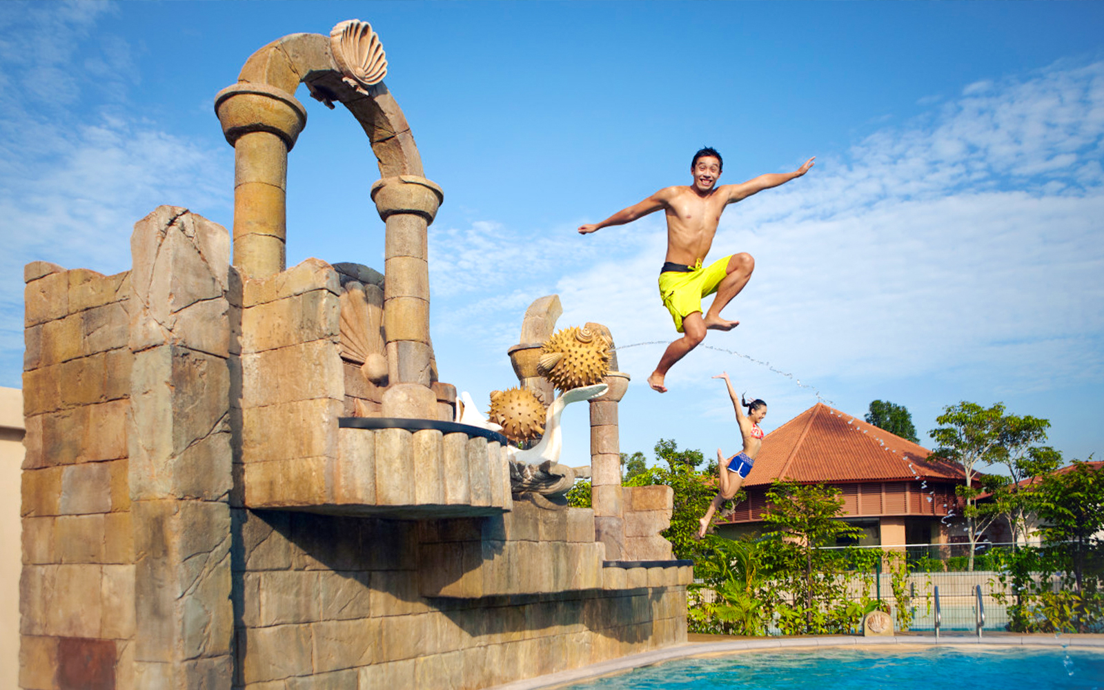 Visitors jumping into a pool at Adventure Cove Waterpark™‎, Singapore.