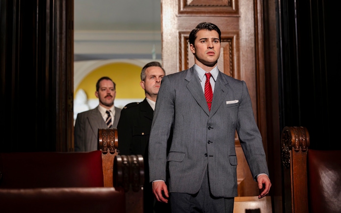 Cast of "Witness for the Prosecution" in courtroom attire on West End stage.