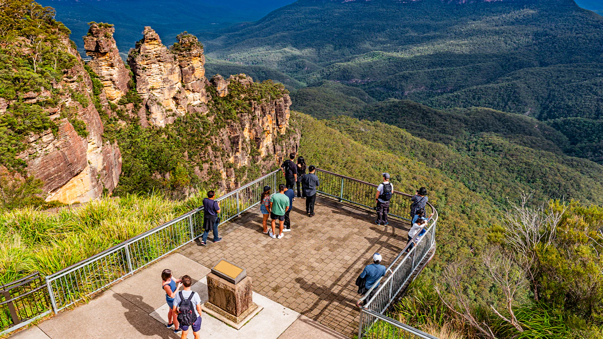 Visitors at Echo Point lookout viewing the Three Sisters rock formation in Blue Mountains, Australia.