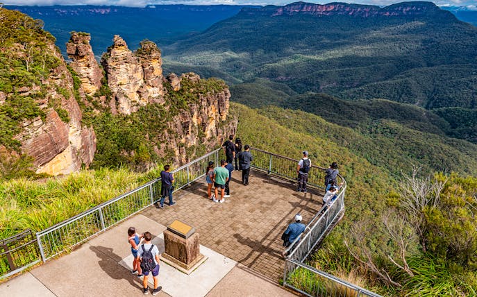 Visitors at Echo Point lookout viewing the Three Sisters rock formation in Blue Mountains, Australia.