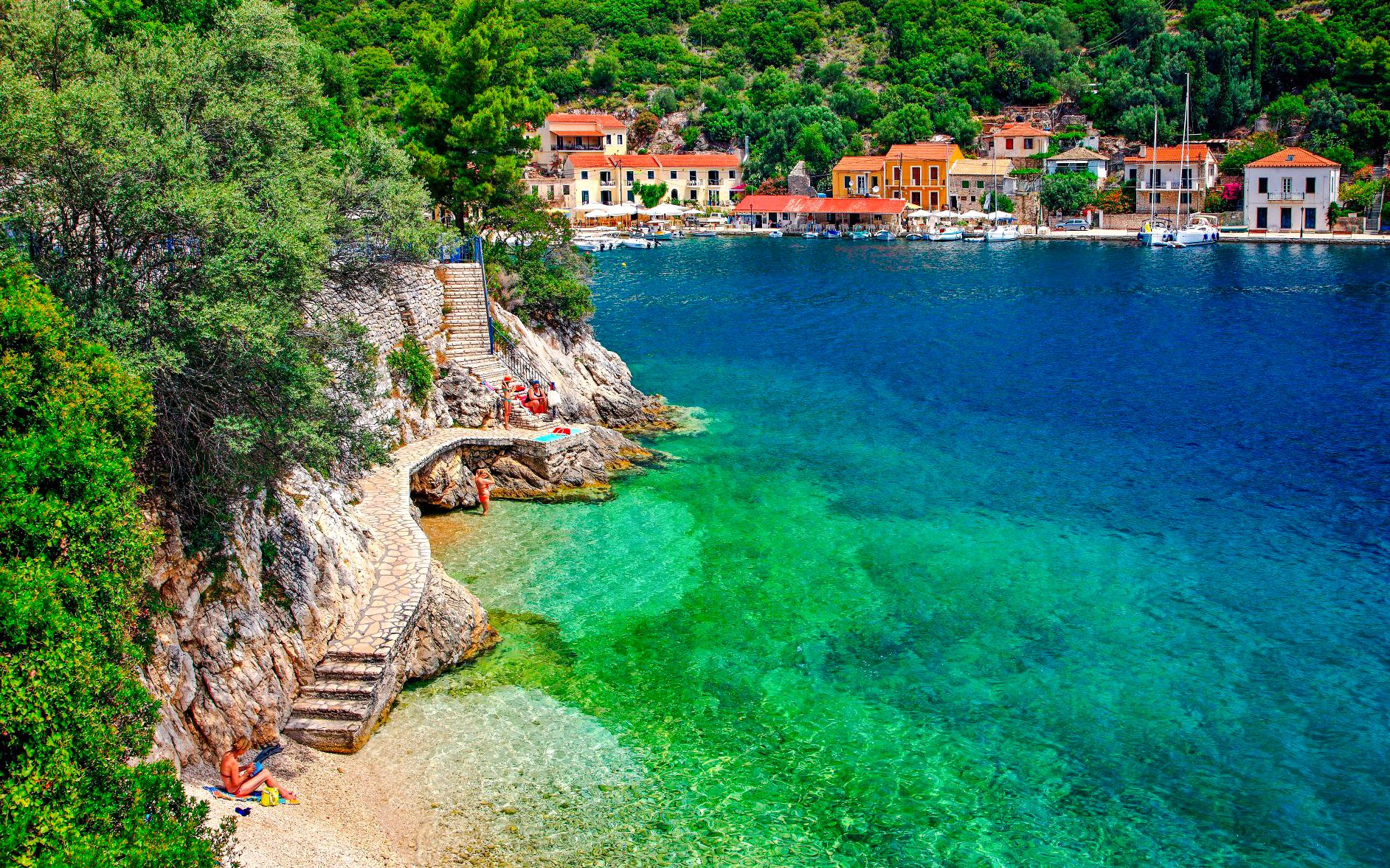 Coastal view of Kioni village, Greece with colorful buildings and clear blue water.