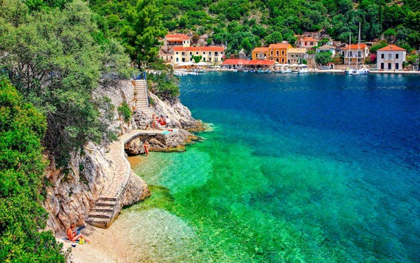 Coastal view of Kioni village, Greece with colorful buildings and clear blue water.
