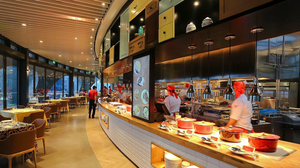 Revolving Restaurant interior at Oriental Pearl Tower, Shanghai, featuring chefs and dining area.