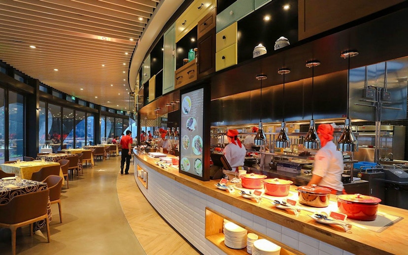 Revolving Restaurant interior at Oriental Pearl Tower, Shanghai, featuring chefs and dining area.
