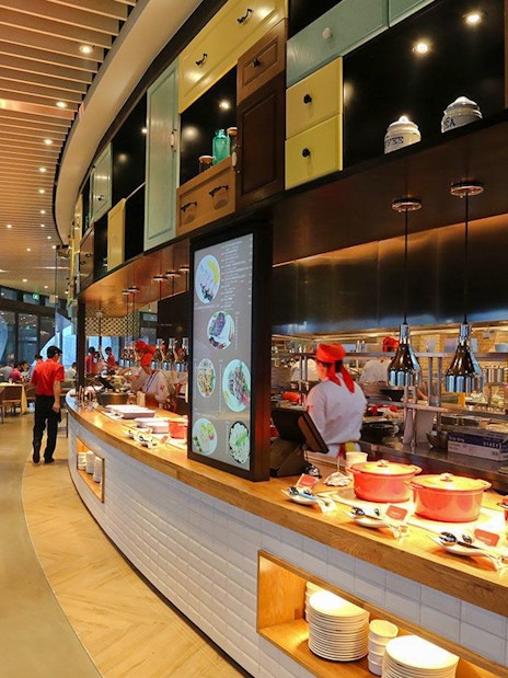 Revolving Restaurant interior at Oriental Pearl Tower, Shanghai, featuring chefs and dining area.