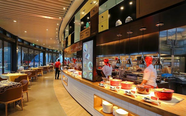 Revolving Restaurant interior at Oriental Pearl Tower, Shanghai, featuring chefs and dining area.