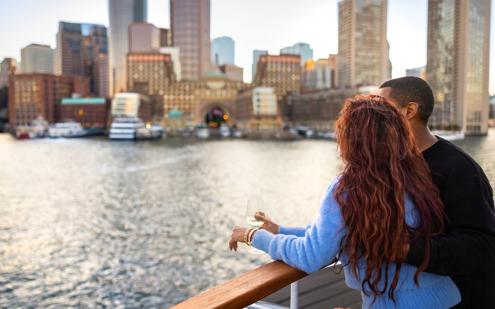 Couple enjoying Boston skyline view on a lunch cruise.