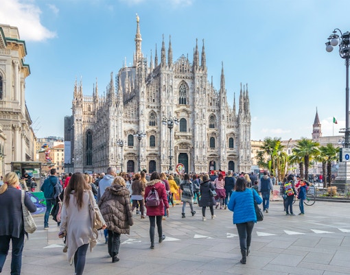 Tourists Milan Duomo in view.