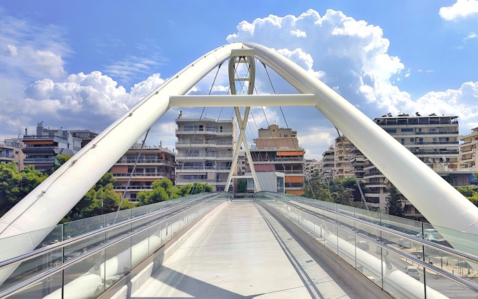 Trocadero footbridge on Posidonos Avenue, Palaio Faliro, with cityscape in background.