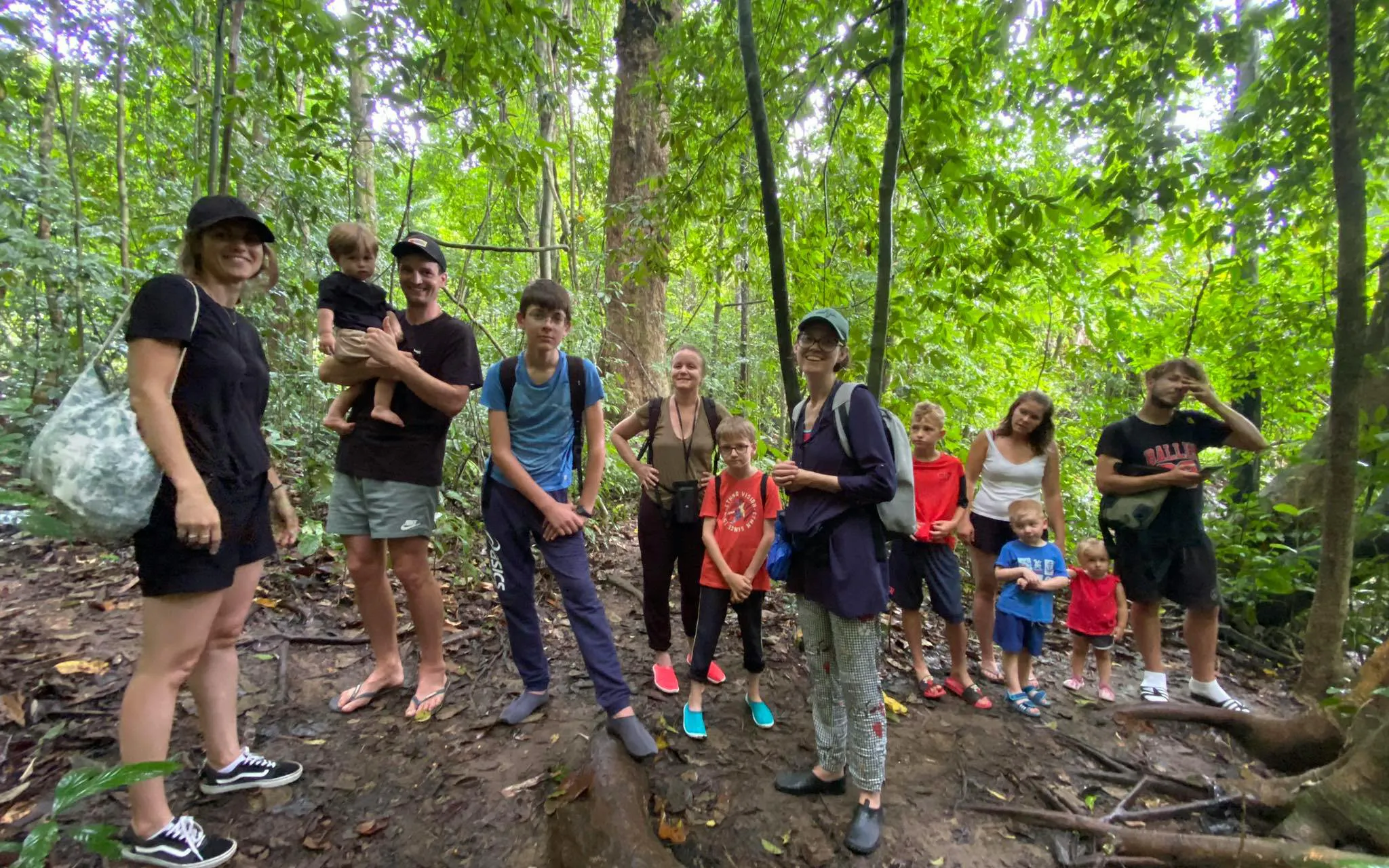 Group hiking in lush jungle on Cheow Lan Lake tour, Krabi.