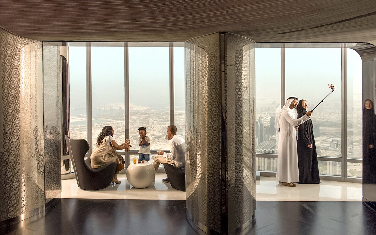 People enjoying refreshments and city view at the lounge, level 148, Burj Khalifa.