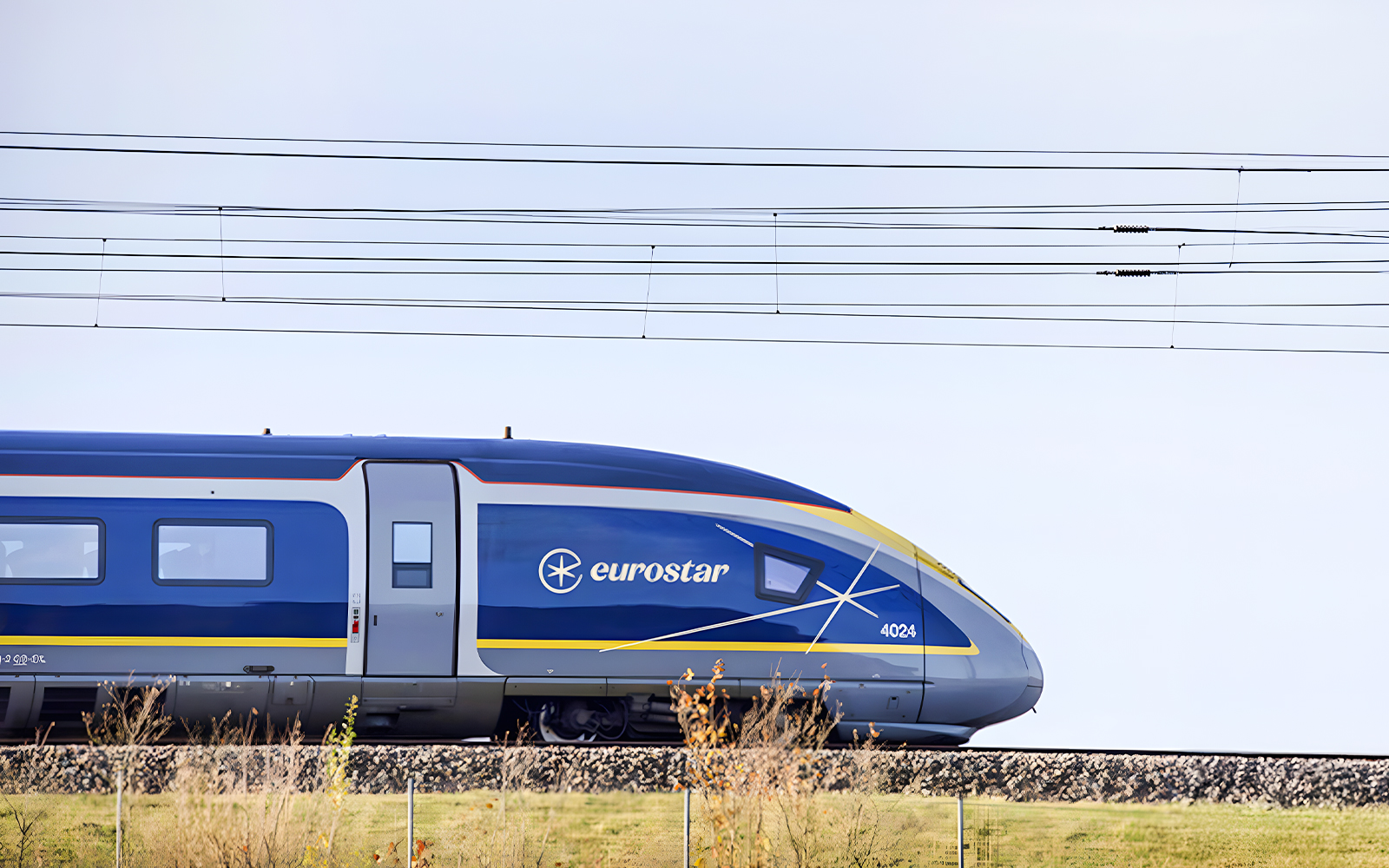 Eurostar train traveling through scenic countryside.