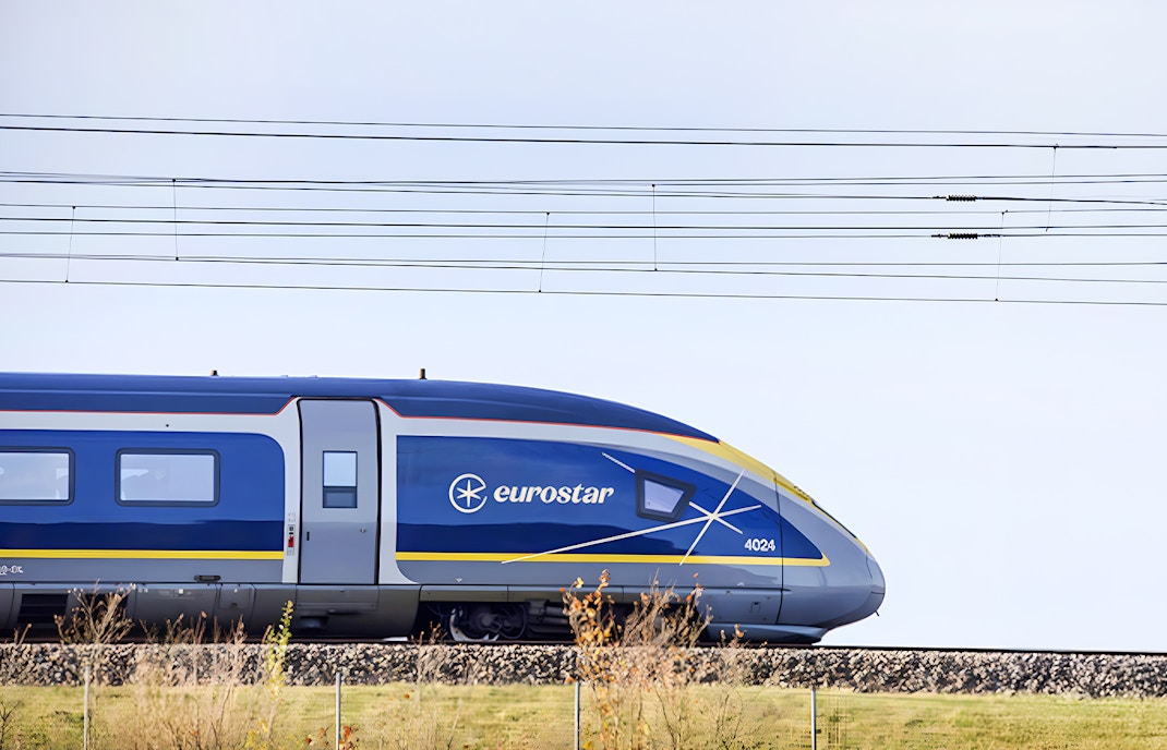 Eurostar train traveling through scenic countryside.