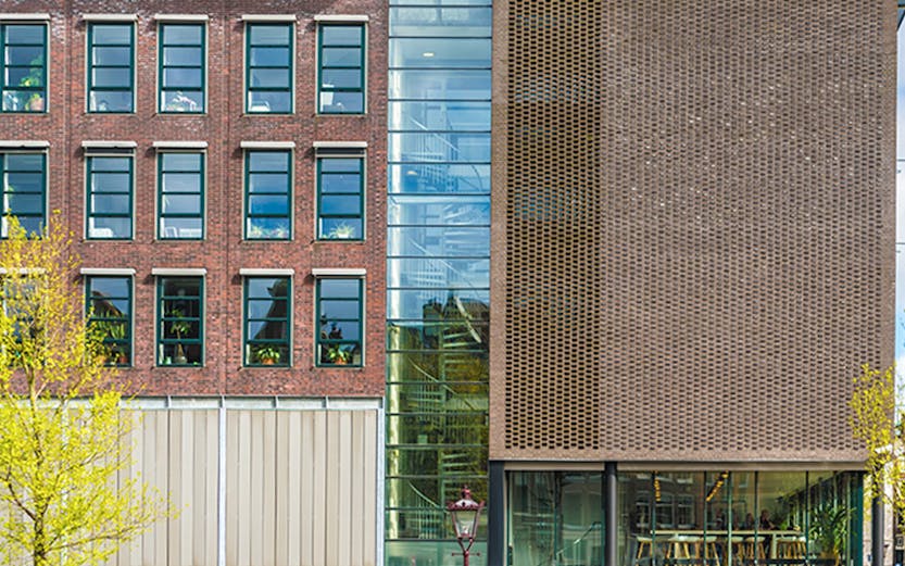 Anne Frank House in Amsterdam with visitors lined up outside.