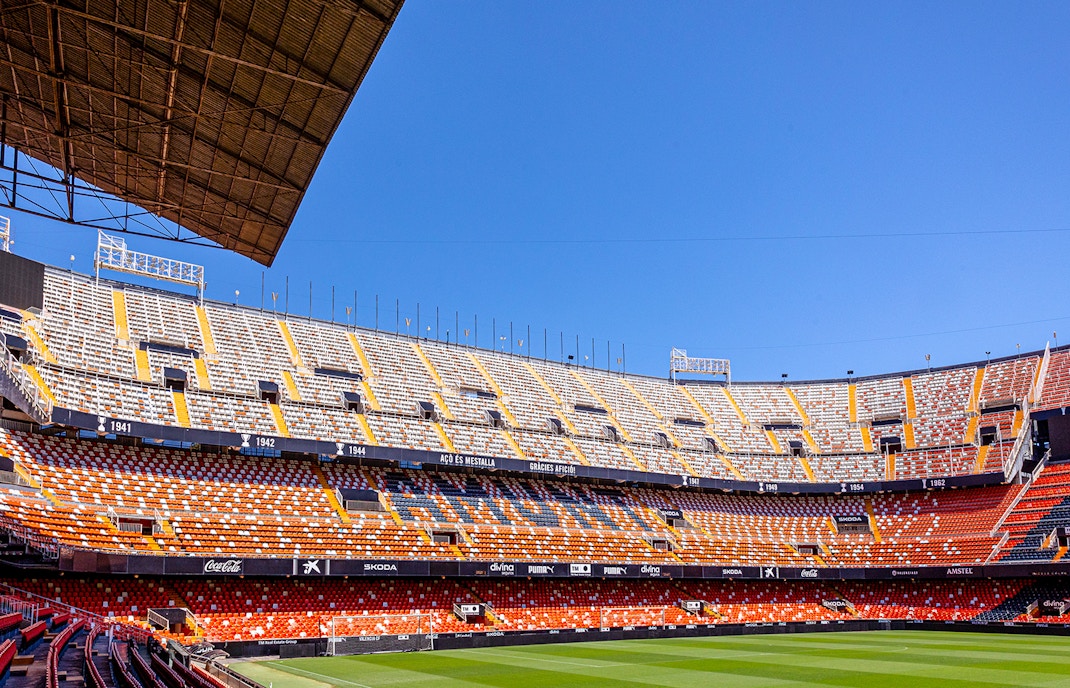 Mestalla Stadium seating and field under clear blue sky in Valencia.