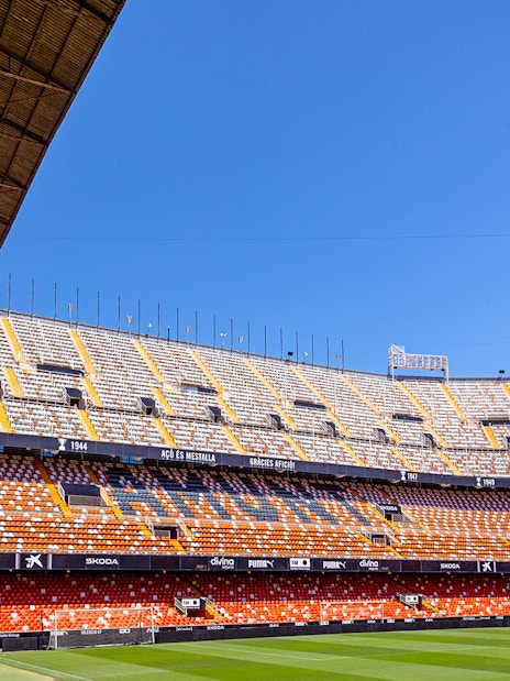 Mestalla Stadium seating and field under clear blue sky in Valencia.