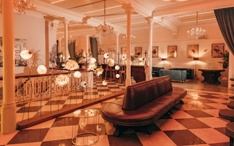 Elegant interior of a Barcelona venue with chandeliers and art, suitable for flamenco performances.