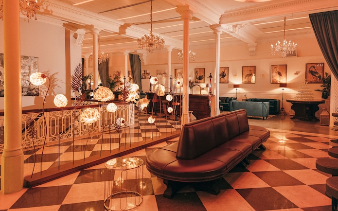 Elegant interior of a Barcelona venue with chandeliers and art, suitable for flamenco performances.