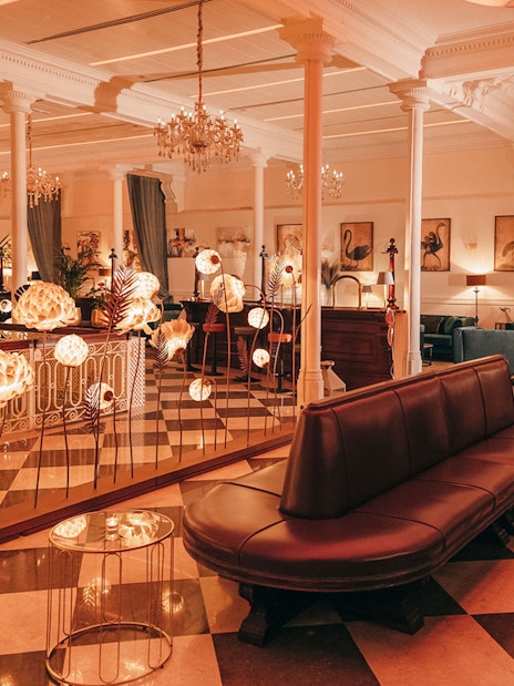 Elegant interior of a Barcelona venue with chandeliers and art, suitable for flamenco performances.