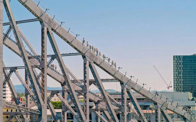 People climbing the Story Bridge in Brisbane during an adventure tour.