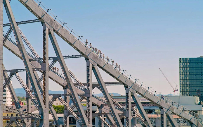 People climbing the Story Bridge in Brisbane during an adventure tour.