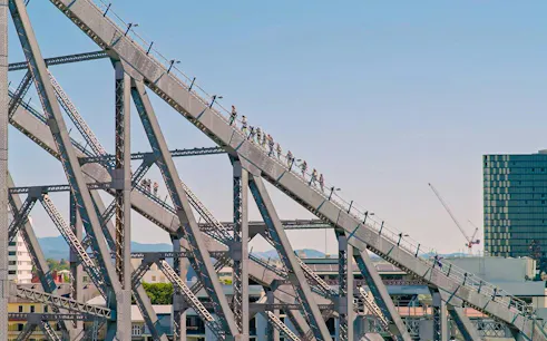 People climbing the Story Bridge in Brisbane during an adventure tour.