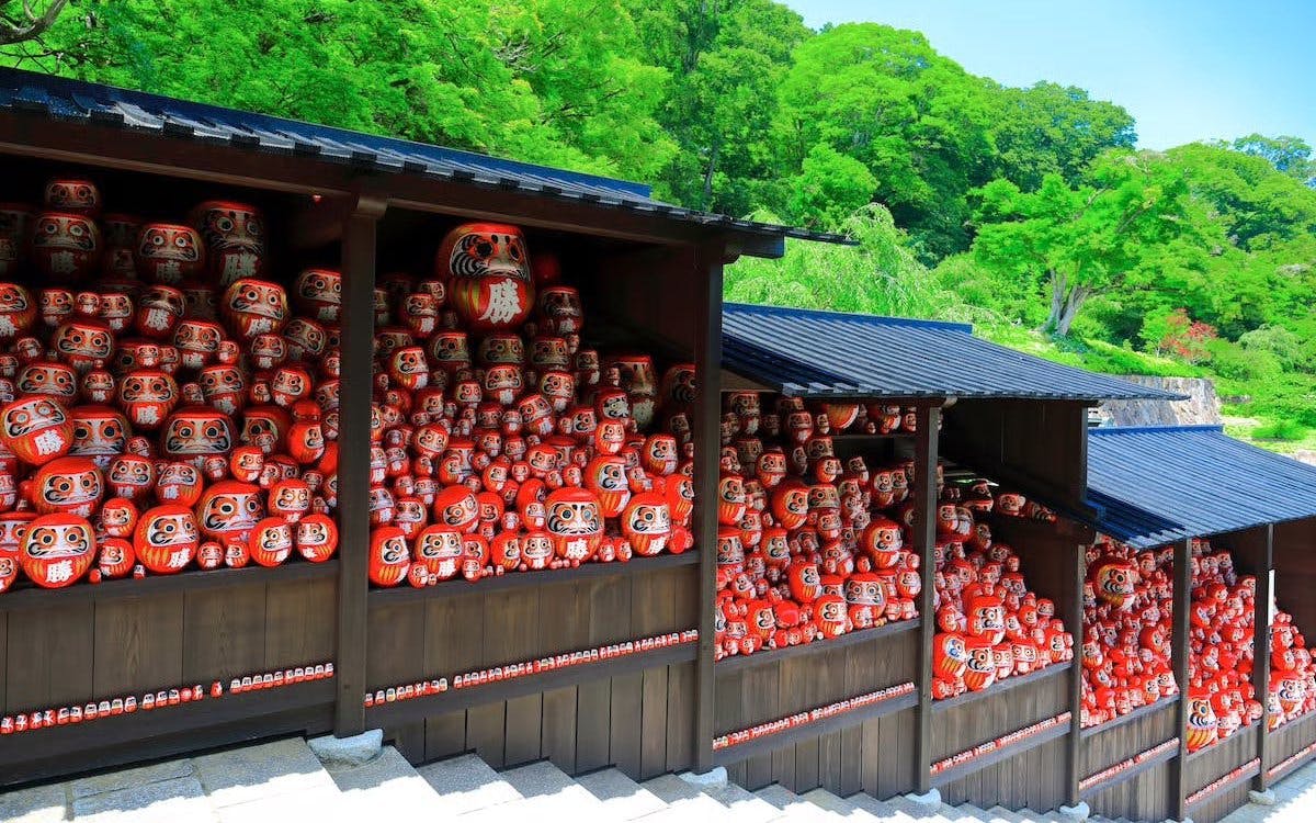 Kachi Daruma dolls on shelves at Katsuo-ji Temple, Japan.