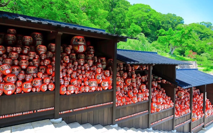 Kachi Daruma dolls on shelves at Katsuo-ji Temple, Japan.