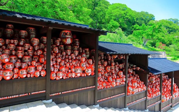 Kachi Daruma dolls on shelves at Katsuo-ji Temple, Japan.