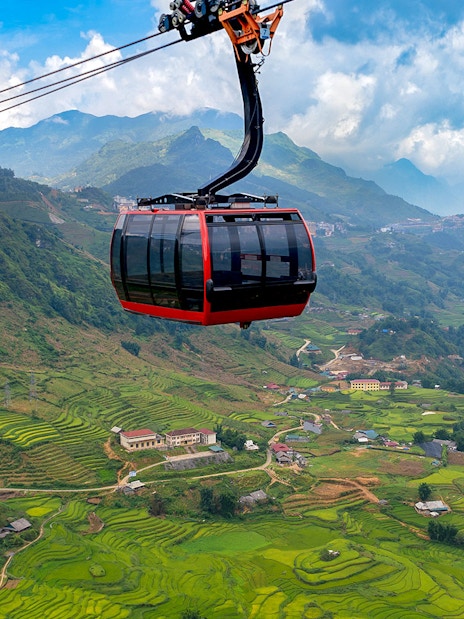 Cable car over terraced rice fields at Sun World Fansipan Legend, Vietnam.