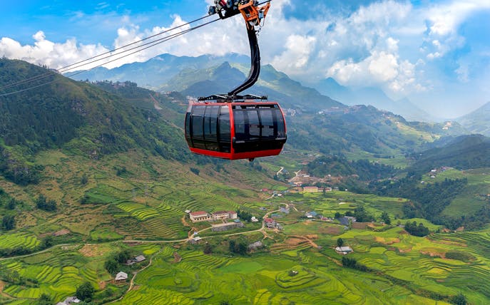Cable car over terraced rice fields at Sun World Fansipan Legend, Vietnam.